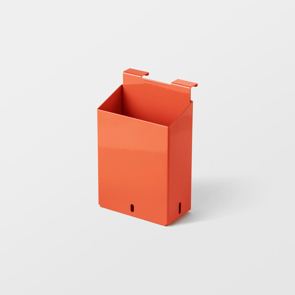 An orange steel magnetic rack container module designed for storing kitchen tools.